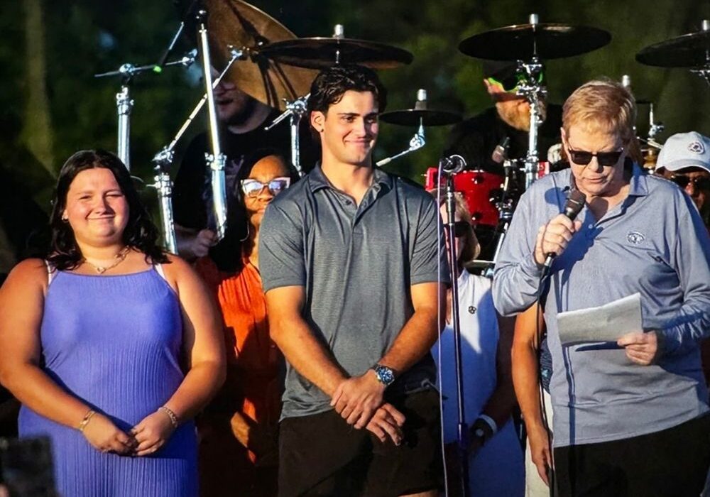 The 2024-25 winners were honored at Taste of Oak Brook last July.  Vija Barber (l) and James Philipneri (c) on stage with committee chairman Tom Truedson (r). 