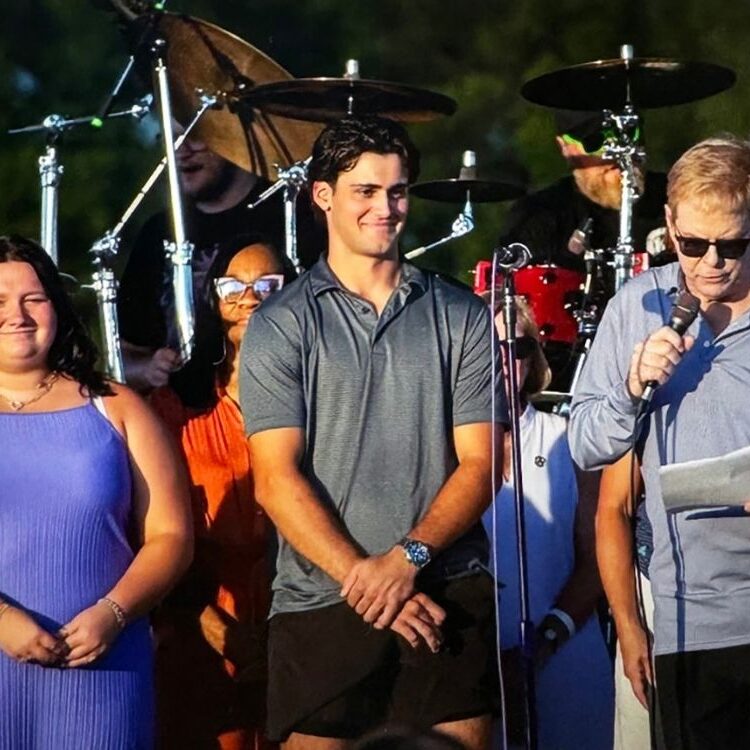 The 2024-25 winners were honored at Taste of Oak Brook last July.  Vija Barber (l) and James Philipneri (c) on stage with committee chairman Tom Truedson (r). 