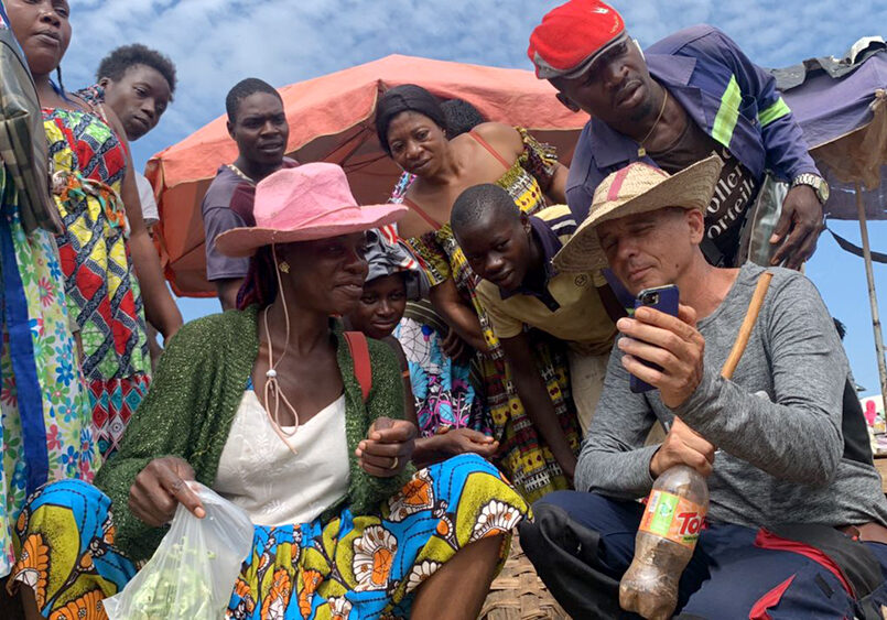 Candid photo of the original creator of the technique used explaining the process and showing on his phone